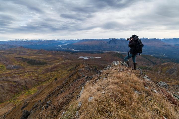 A Photographer taking pictures from a peek