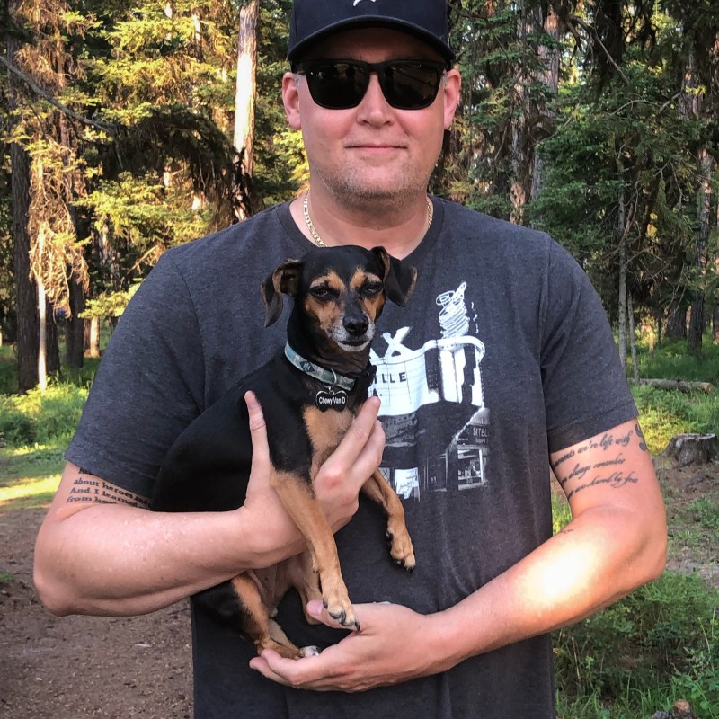 Paul Boomhower a person holding a dog posing for the camera