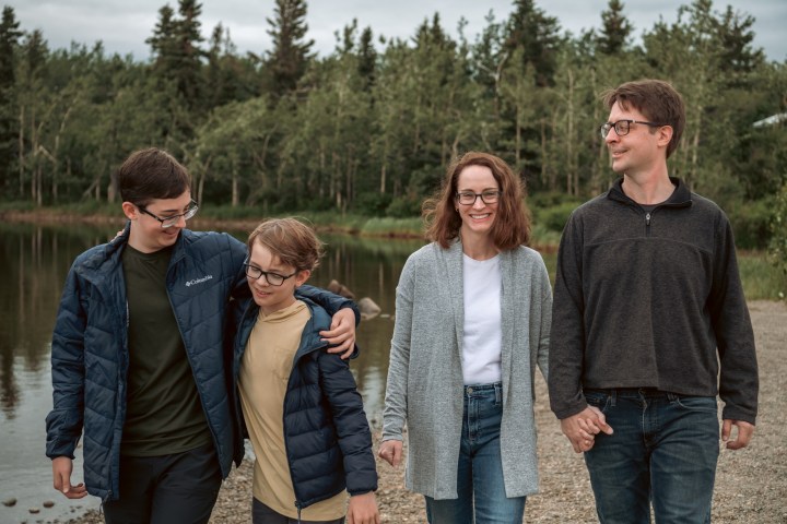 a group of people standing together smiling for the camera