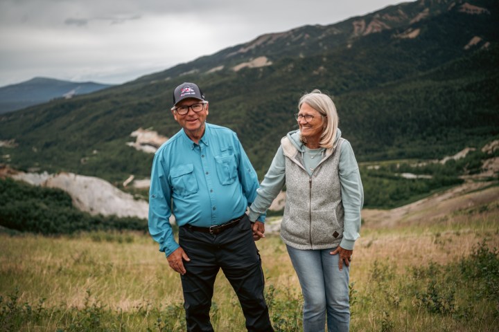 a person standing in front of a mountain